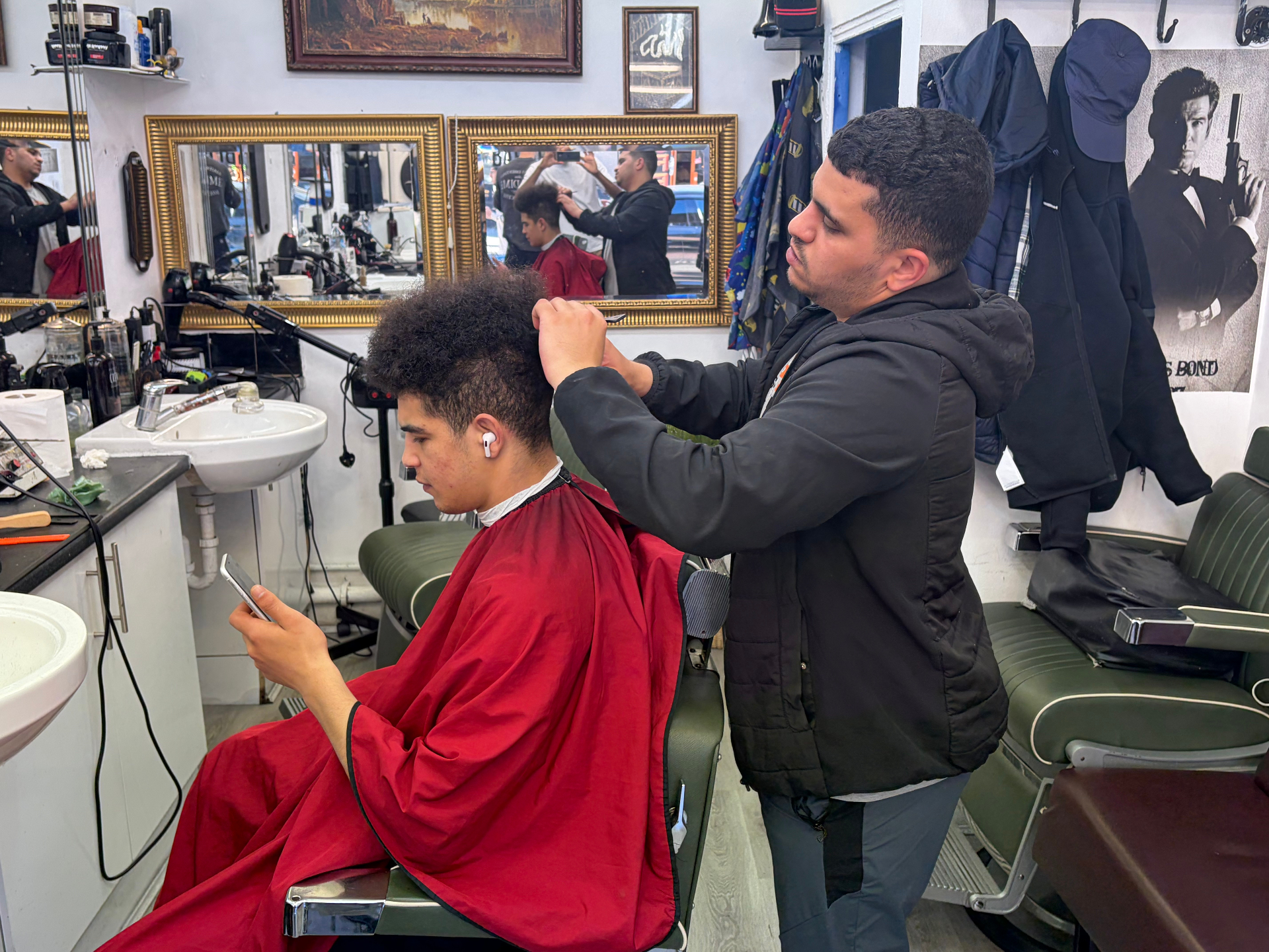 Barber shaping a textured cut at Legends Barbers
