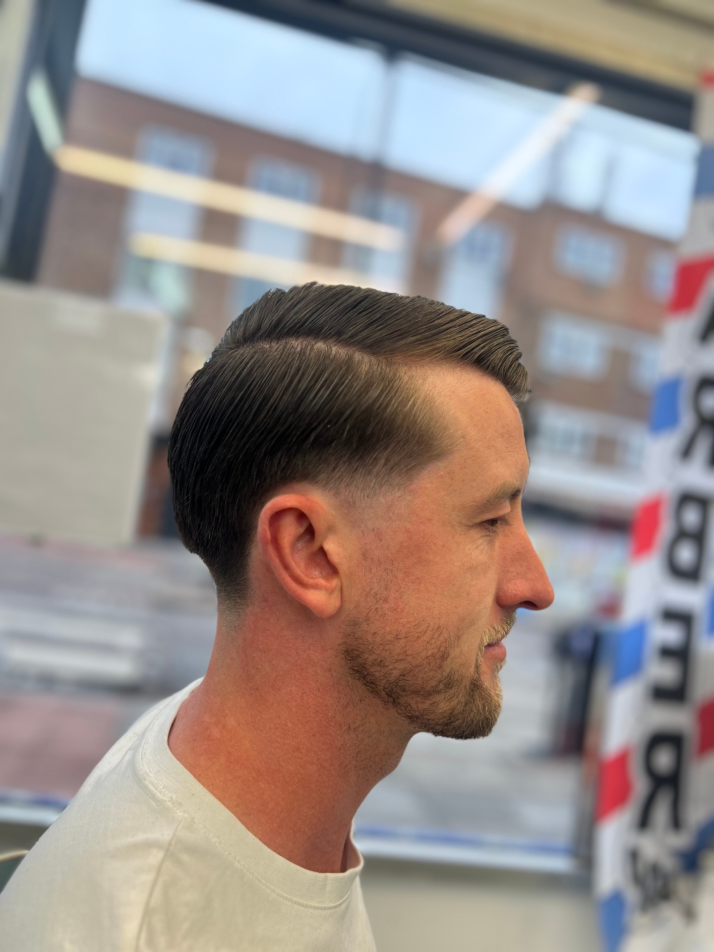 Classic side-part with taper fade by Legends Barbers